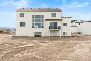 Rear view of property featuring a mountain view and stucco siding