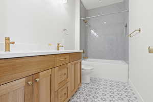 Full bath featuring vanity, bathtub / shower combination, and toilet