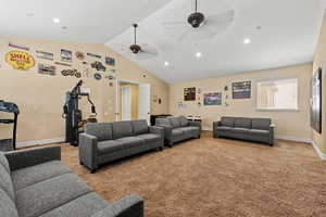 Carpeted living room featuring recessed lighting, baseboards, a ceiling fan, and lofted ceiling