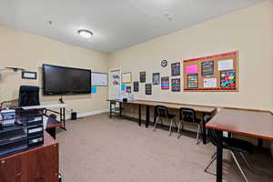 Carpeted home office with baseboards