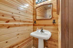Bathroom featuring wooden walls