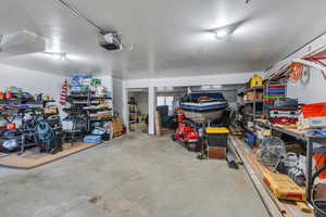 Garage featuring a workshop area and a garage door opener