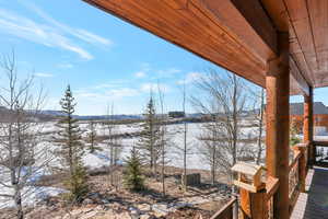 Snow covered deck with a mountain view