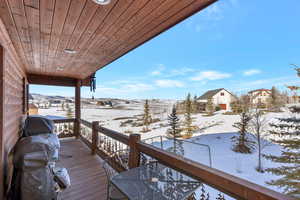 Snow covered deck featuring area for grilling