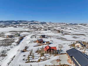 Snowy aerial view featuring a mountain view