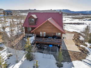 Exterior space featuring a mountain view, metal roof, and fence