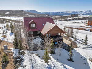 Snowy aerial view featuring a mountain view