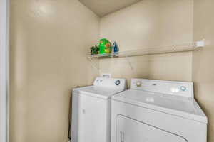 Laundry area featuring independent washer and dryer and laundry area