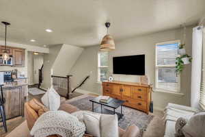 Living room featuring baseboards, plenty of natural light, and a textured ceiling