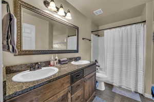 Bathroom with tile patterned flooring, visible vents, a sink, and toilet