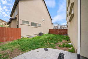 Exterior space featuring a patio area, central AC, and fence
