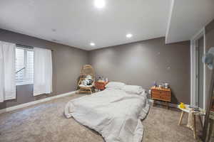 Carpeted bedroom with baseboards and recessed lighting