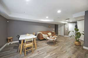 Dining area with visible vents, baseboards, recessed lighting, and wood finished floors