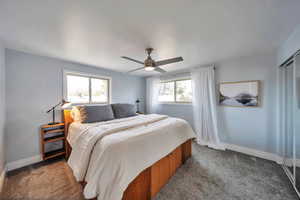 Bedroom with carpet floors, baseboards, and ceiling fan