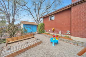 Exterior space featuring fence and brick siding