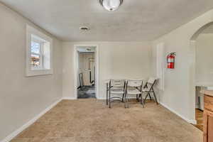 Dining room featuring baseboards, visible vents, and arched walkways