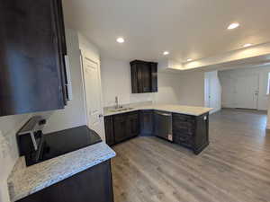 Kitchen featuring stainless steel dishwasher, light wood-style flooring, recessed lighting, a sink, and electric stove