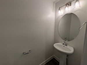 Bathroom with baseboards and wood finished floors