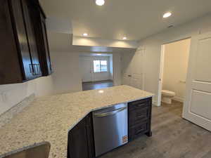 Kitchen with visible vents, dishwasher, a peninsula, recessed lighting, and dark wood-type flooring