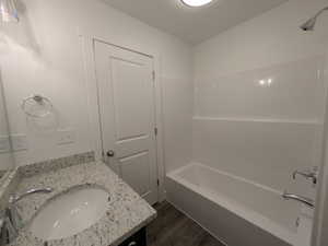 Full bathroom featuring shower / bath combination, wood finished floors, and vanity