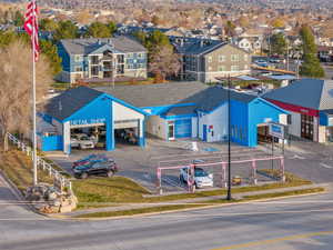 View of building exterior featuring uncovered parking and a residential view