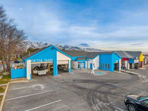 View of building exterior with uncovered parking and a mountain view