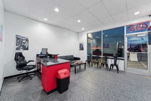 Office space featuring baseboards, recessed lighting, and a drop ceiling