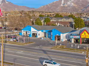 Exterior space featuring street lights, a mountain view, sidewalks, and curbs