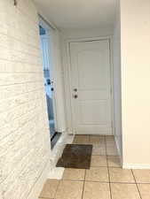 Entryway with light tile patterned flooring