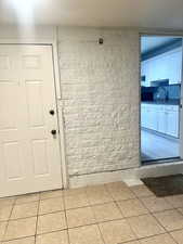 Interior space featuring a sink and light tile patterned flooring