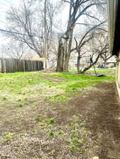 View of yard featuring fence
