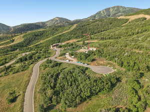 Aerial overview of property's location featuring a mountainous background