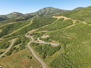 Aerial overview of property's location featuring a mountain backdrop