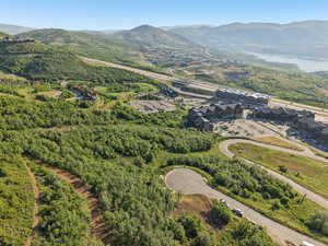 Aerial view of property and surrounding area featuring mountains
