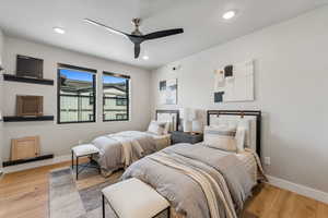 Bedroom with recessed lighting, light wood-style floors, baseboards, and a ceiling fan