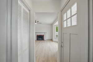 Hall featuring light wood-style flooring and baseboards