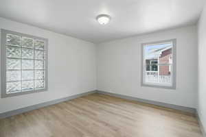 Empty room featuring light wood-type flooring and baseboards