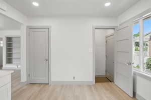 Unfurnished bedroom with light wood-style flooring and recessed lighting