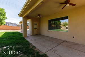 View of patio with fence and a ceiling fan