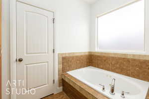 Bathroom with tile patterned flooring and a whirlpool tub