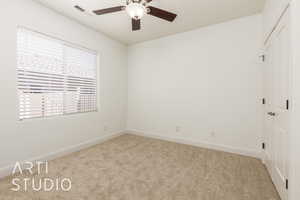 Unfurnished bedroom with carpet, visible vents, a closet, and multiple windows