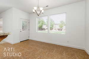 Unfurnished dining area with light tile patterned floors, a notable chandelier, visible vents, and baseboards