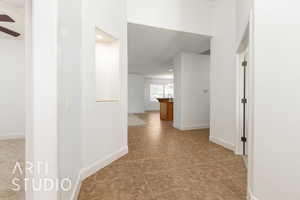 Hall with recessed lighting and baseboards