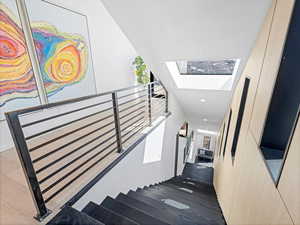 Stairway featuring a skylight and recessed lighting