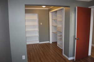 Interior space featuring baseboards and wood finished floors