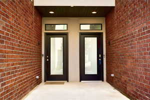 Property entrance featuring brick siding