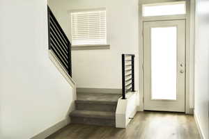 Entryway with stairway and wood finished floors