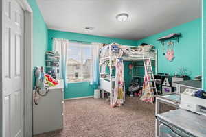 Bedroom featuring carpet flooring, visible vents, and baseboards