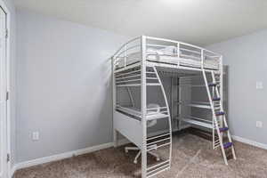 Unfurnished bedroom with baseboards and carpet flooring