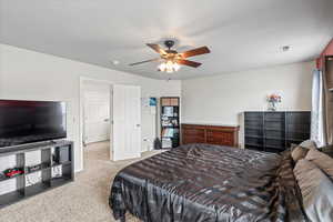 Bedroom with ceiling fan, carpet, and visible vents